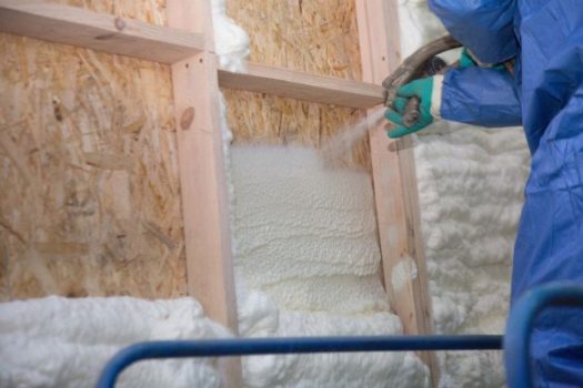 Worker applies spray foam to the walls of a Birmingham, MI home