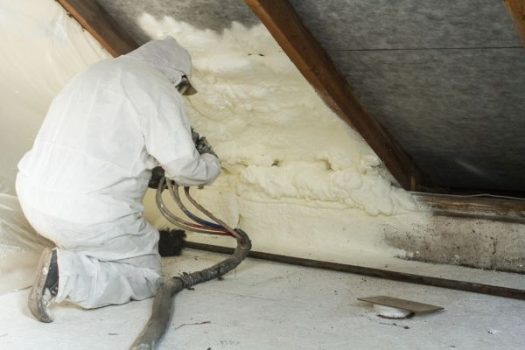 worker installs spray foam insulation at a home in Novi, MI